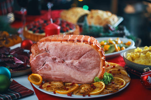 istock Christmas Dinner with Baked Glazed Ham and Various Vegetables 1726441657