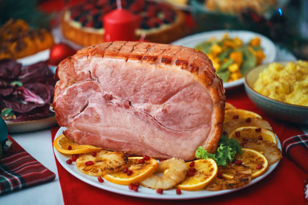 istock Christmas Dinner with Baked Glazed Ham and Various Vegetables 1726441658
