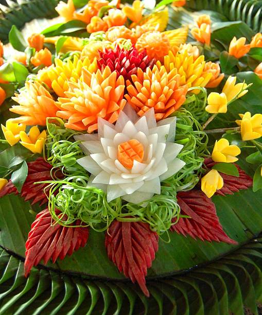 Thai Fruit Carvings A platter of vegetables carved in the traditional Thai way carving fruit stock pictures, royalty-free photos & images