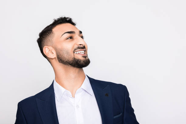 istock Delighted smart young handsome turkish man in smart ellegant suit standing over grey background in studio isolated 1726452241