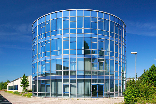 blue sky reflecting in a completely cylindrical building