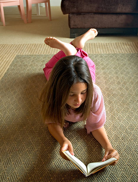 Young Girl Reading On Floor