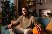 An African American blogger shares his passion for basketball and life in front of the camera, holding the ball that drives him and smiling with joy