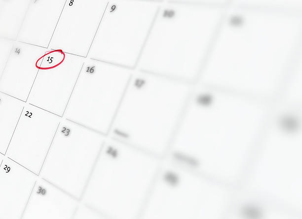 April 15 - 1 Close-up of calendar page with the 15th circled in red, soft selective focus april photos stock pictures, royalty-free photos & images