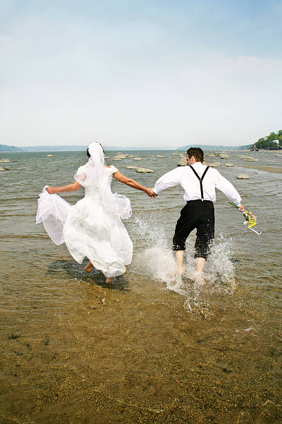 istock Just married running in water I 172647174