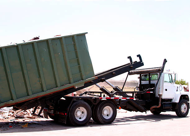 City truck unloading dumpster of trash