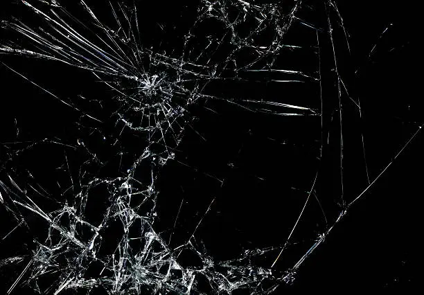 Photo of Shattered glass in dark background