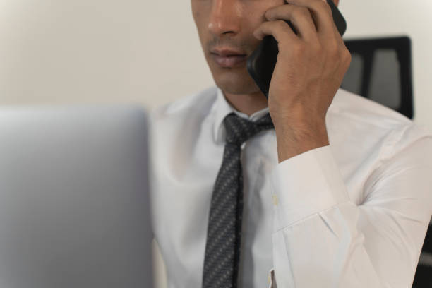 Young businessman working at home. Young man working with computer. Young man working freelancer. Man using cell phone.