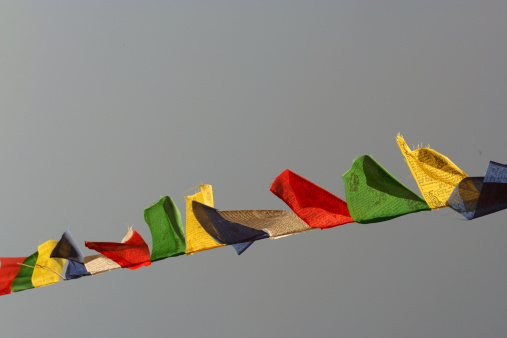 Colourful Buddhist prayer flags fluttering in the breeze on a sunny day, Kathmandu, Nepal