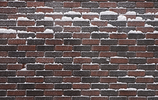 Brick wall covered with snow