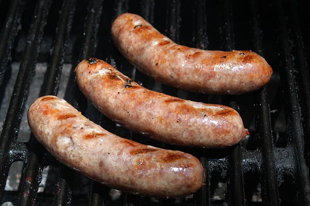 Grilling: Brats on the grill Wisconsin brats on the grill after being boiled in beer.... yummy! sulking stock pictures, royalty-free photos & images