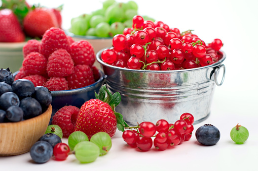 A delicious selection of summer vine riped berries including, strawberries, raspberries, blueberries, gooseberries and red currants.