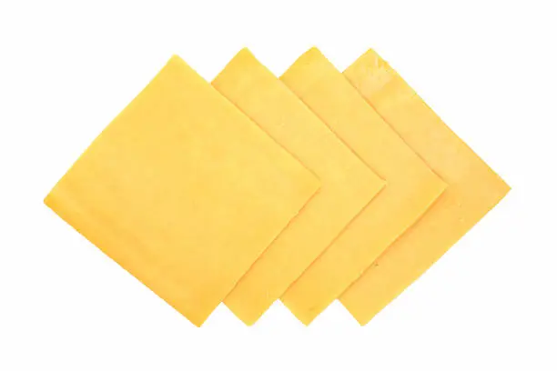 "Slices of cheddar cheese, for sandwiches. Isolated on white. Part of my sandwich ingredients series."