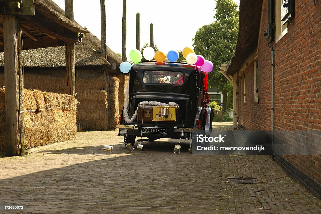 Just married Driving away with cans behind the car Can Stock Photo