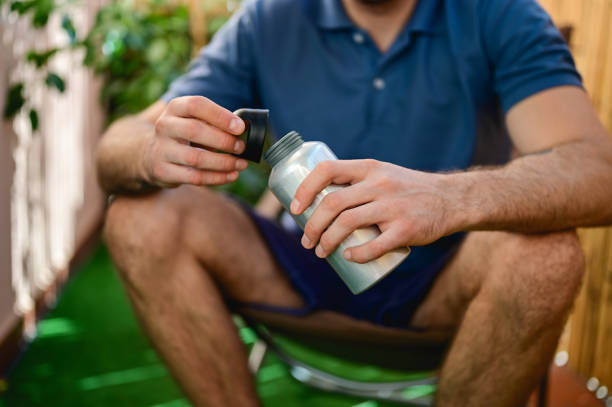 istock midsection of a man holding water bottle. 1726507296