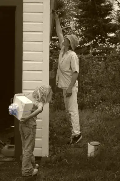 A little girl delivering a fathersday gift.