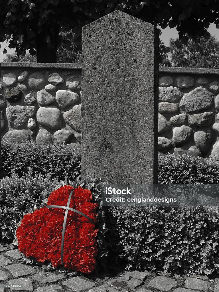 Cross My Heart A heart of red carnations decorates a lone headstone in a small European country cemetery; black and white monochrome version. Carnation - Flower Stock Photo