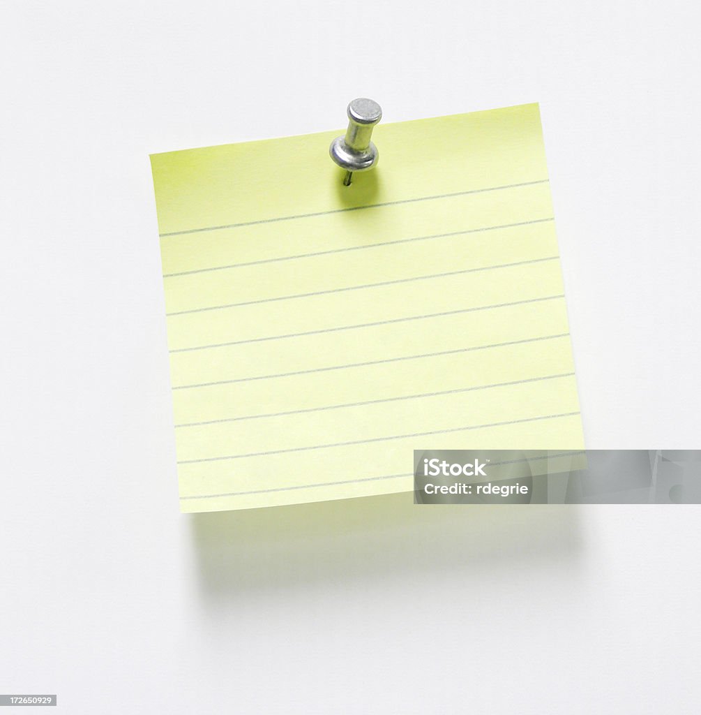 Pushpin and Note w/ optional clipping path "Silver pushpin holding small, lined, blank yellow paper on a light gray background with shadow and optional clipping path." Adhesive Note Stock Photo