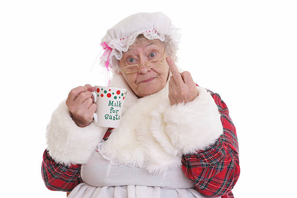 Stealing milk flip off Mrs Claus Character Humor. Mrs Claus flipping the bird while holding Santa's milk. irritation photos stock pictures, royalty-free photos & images