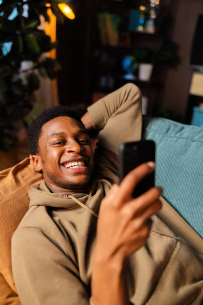 istock Happy African American dark skinned young professional taking a break from work, enjoying some downtime in his cozy living room resting relaxing freelance concept 1726512131