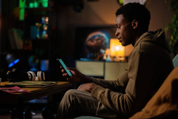 istock African American man social media influencer checking notifications posting updates on phone while editing content for his followers on his laptop 1726514529