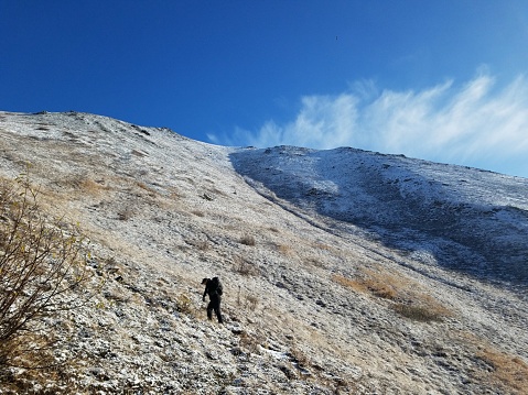 One woman hiking in the Chugach Mountains in  Alaska