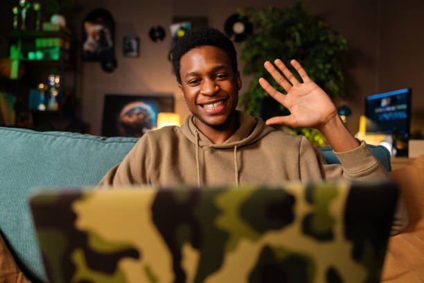 istock African American dark skinned black student, studying online for a degree or certification. He could be working on an assignment or watching a lecture waving to new claasmates 1726523350