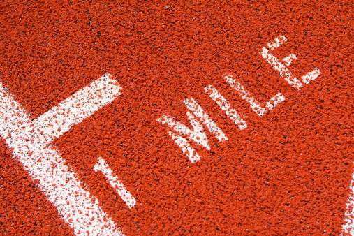 Close-up of one (1) mile mark on red running track
