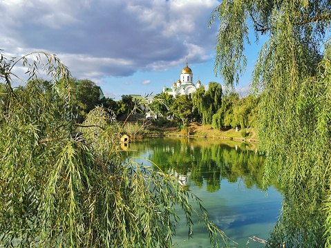 Tiraspol, Transnistria, Moldova - September 16, 2023. View of Orthodox Church and beautiful pond in the center of the city.