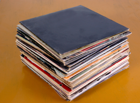 Stack of old vinyl records on a wood surfaceRelated pics