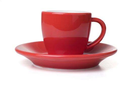 Red espresso coffee cup and saucer.  Isolated on white with clipping path.