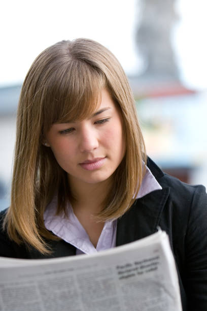 istock Girl reading a newspaper 172653184