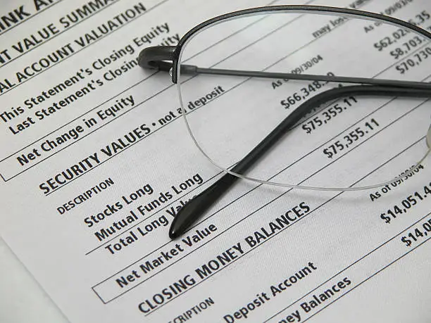 Photo of Financial Statement and Glasses