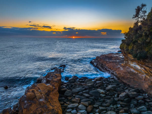 istock Sunrise over the ocean with low clouds on the horizon 1726542966