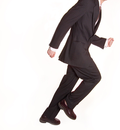 A man in a business suit running.