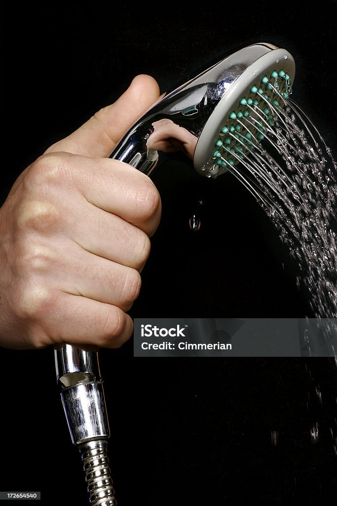 Shower head A hand with a shower isolated on black. Adult Stock Photo