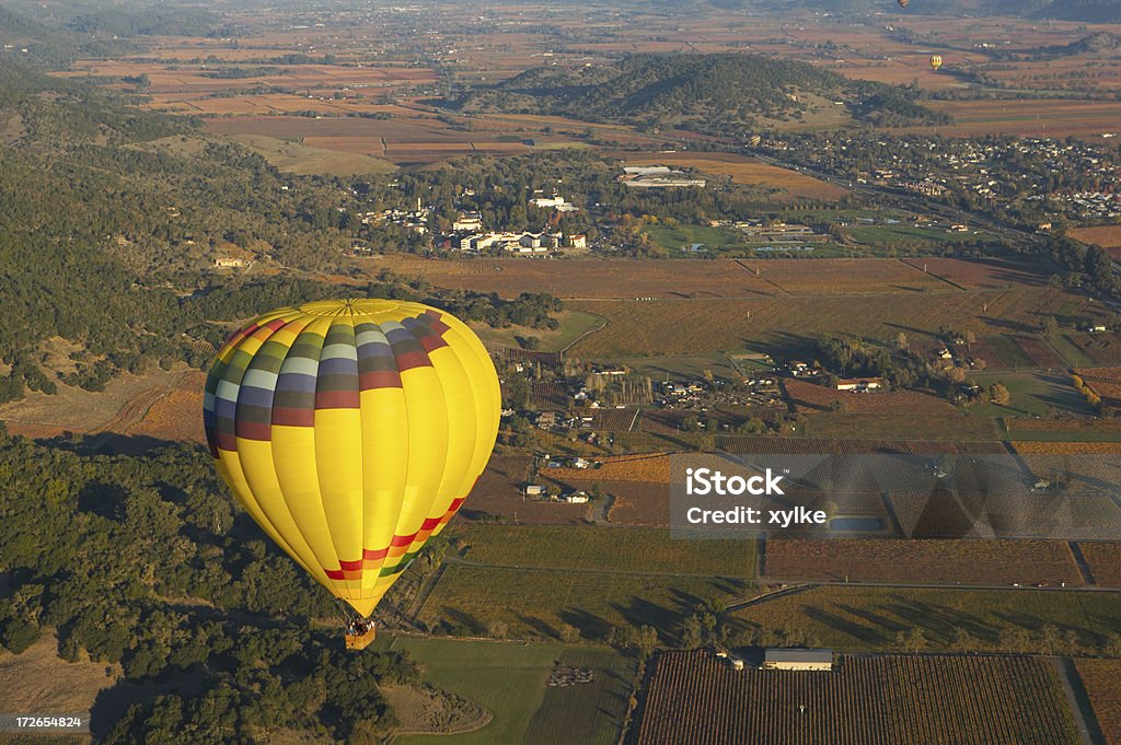 hot air balloon Hot air balloon in the foreground with farmland below Aerial View Stock Photo