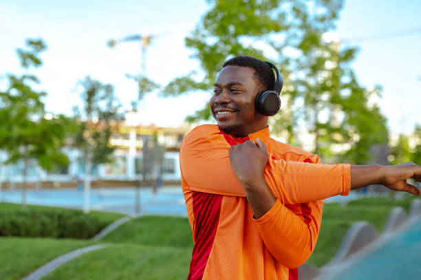 istock A young African American man smiling and stretching to prepare for his run, while cheerfully listening to music 1726552158