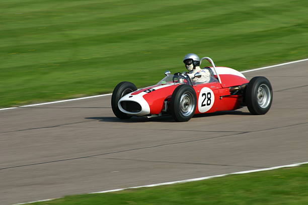 istock Antique red and white race car going fast on Indy track 172655224