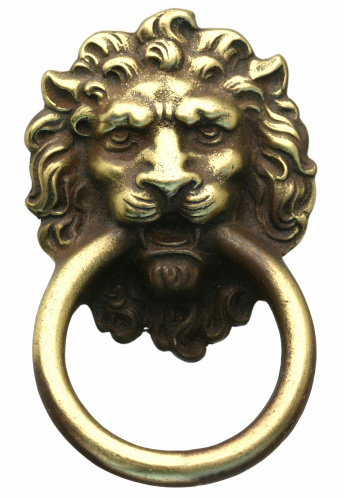 Lion's head door knocker isolated on white.