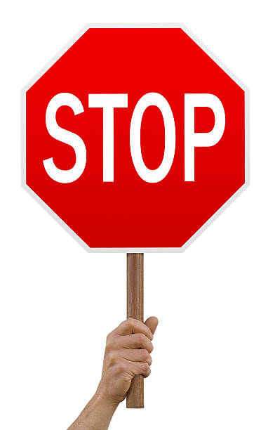 Hand holding up red octagonal stop sign stop sign,isolated on white, stop single word stock pictures, royalty-free photos & images