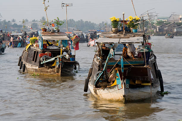 A view of a river, boats and fisherman and the city of Saigon, Vietnam