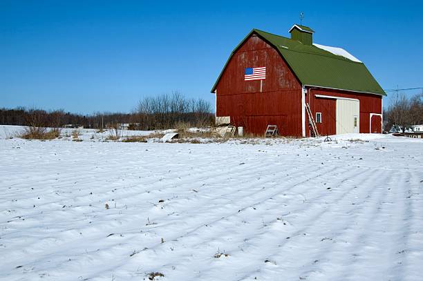 Patriotic Barn with American Flag in Winter stock photo