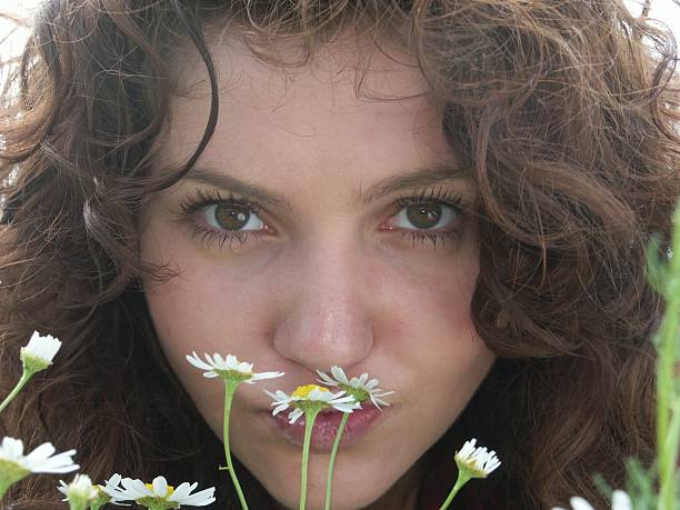 Studio shot of an attractive woman holding a bouquet of flowers