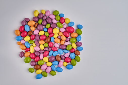 Multi-colored candies on a light background. Candy dragees. Candy background