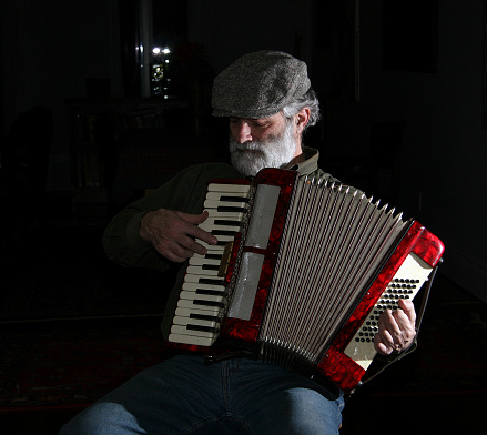 This is a picture of a man playing the accordion. 