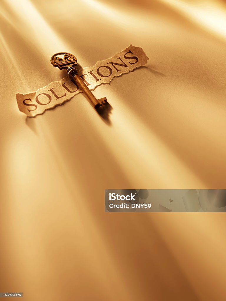 Key to Solutions Key to solutions. Shot with warm tungsten light streaming across image.To see more of my keys click the link below: Creativity Stock Photo