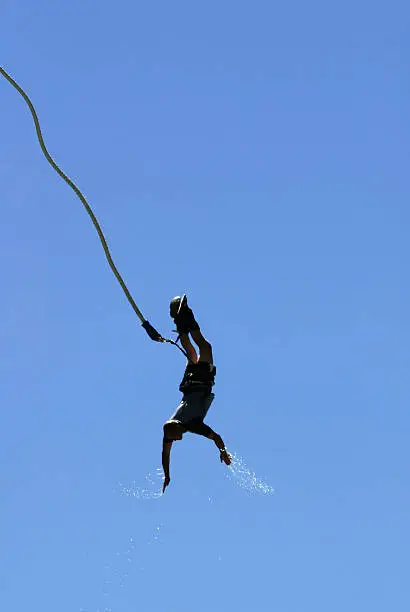 "Bungee jumper on the upswing with water coming off his hands, over the Kawarau river near Queenstown, New Zeland."