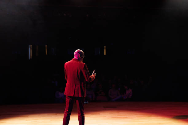 istock Bald man giving a speech in front of an audience 1726577262