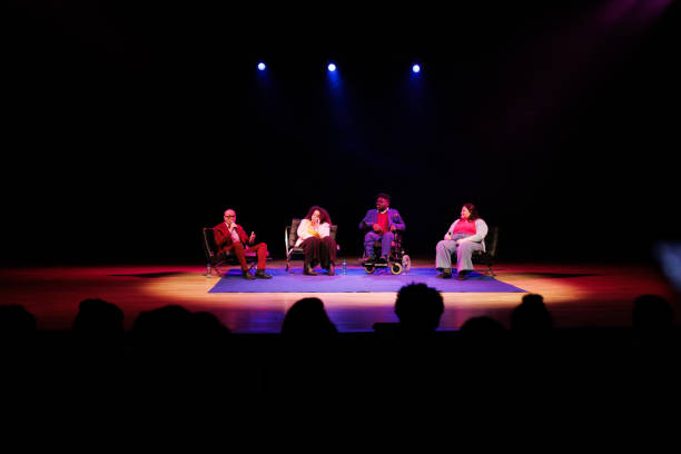 istock Group of people sitting on a stage giving a speech to an audience 1726578845